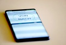 Ein Smartphone mit geöffneter ÖPNV-Fahrplansuche liegt auf dem Tisch. Foto: Volkmann
