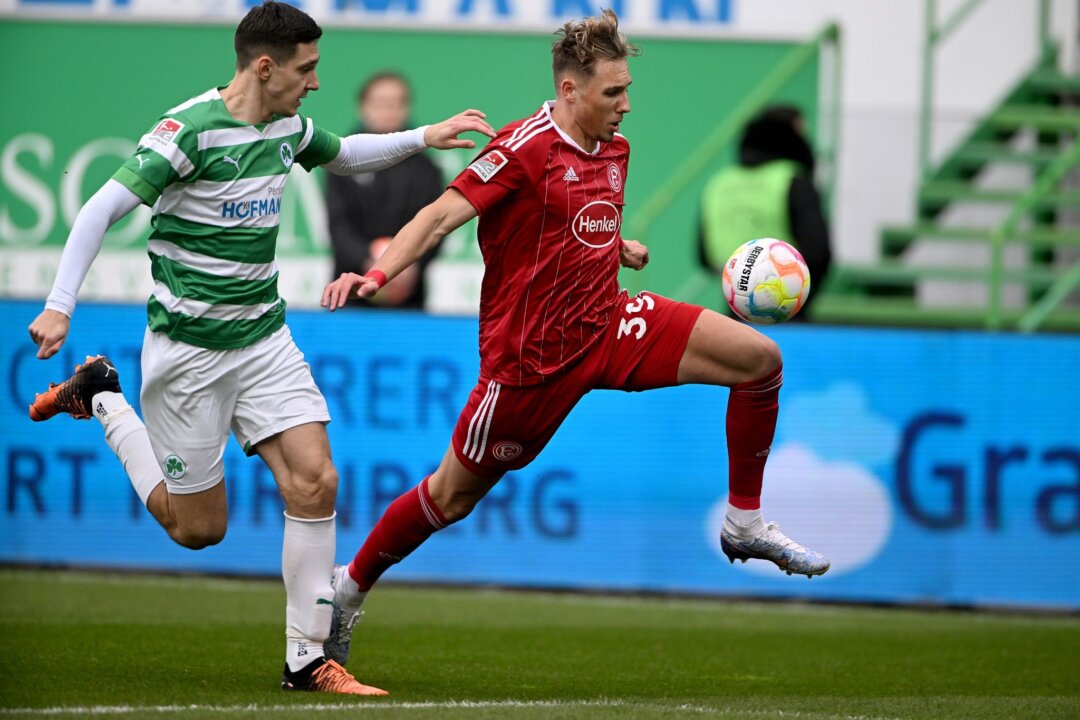 Der Fürther Damian Michalski (l) und Düsseldorfs Jona Niemiec kämpfen um den Ball.