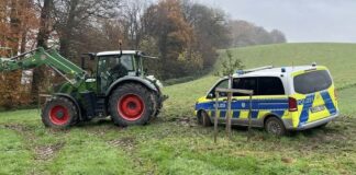 Ein Landwirt zog den Einsatzwagen mit einem Traktor vom Acker. Foto: Polizei