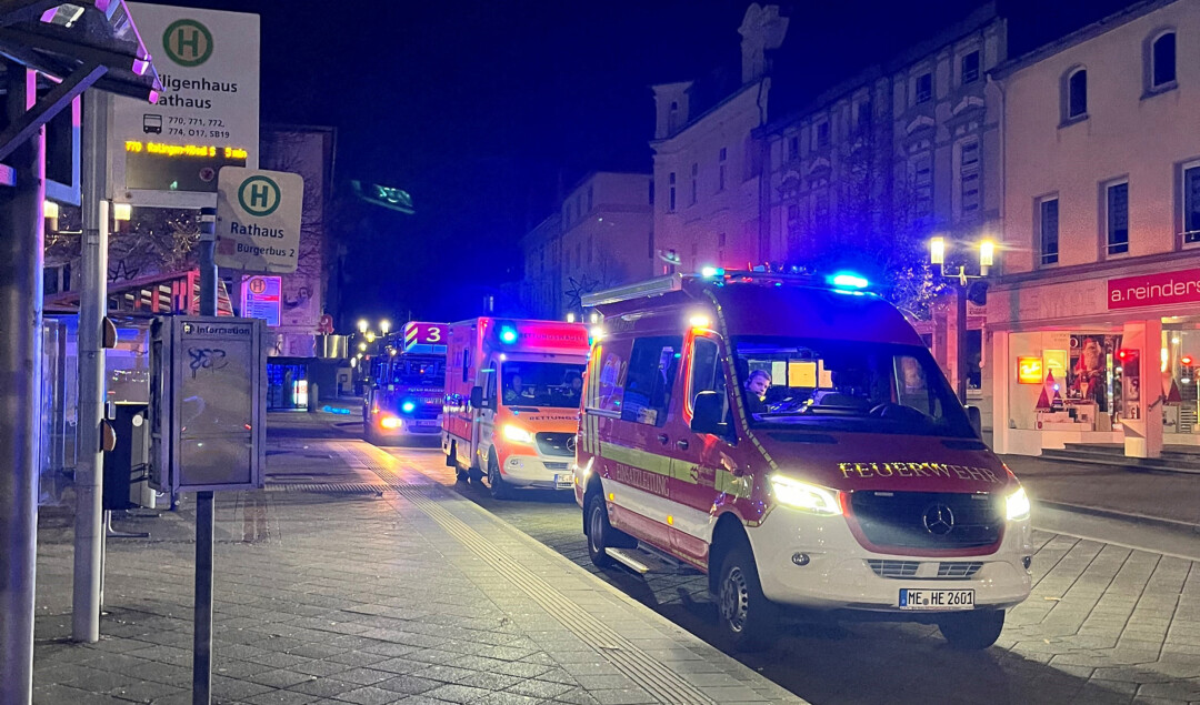 Einsatzfahrzeuge der Feuerwehr nachts in Stadt.
