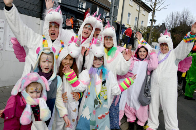 Gruppe in Einhorn-Kostümen feiert Karneval.