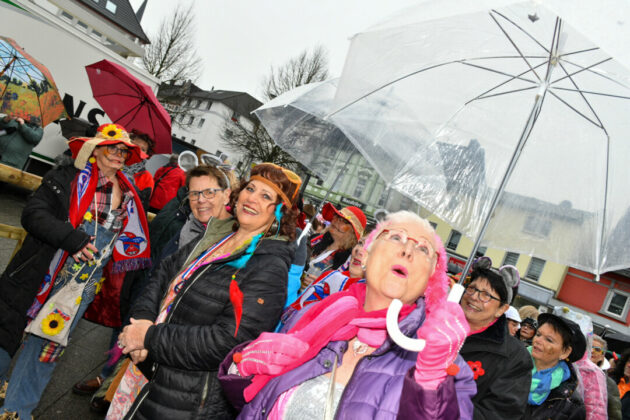 Menschen feiern Fasching trotz Regen.