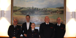 Der Leiter der Freiwilligen Feuerwehr Erkrath Markus Steinacker, Bürgermeister Christoph Schultz, die neue stellvertretende Leiterin der Freiwilligen Feuerwehr Erkrath Dr. Kim Sara Doht, der ehemalige stellvertretende Leiter der Freiwilligen Feuerwehr Erkrath Jörg Schmitter und Erkraths Feuerwehr-Chef Guido Vogt bei der Urkundenübergabe. Foto: Stadt Erkrath