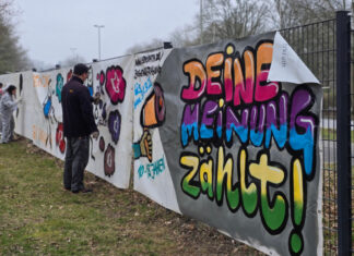Um möglichst viele junge Menschen anzusprechen, wurde auf dem Gelände der Carl-Fuhlrott-Schule in Hochdahl eine Graffiti-Aktion mit dem Künstlerduo Tran Nguyen und Imke Hofmann durchgeführt. Auf mehreren Bauzaunbannern konnten Jugendliche ihre eigenen künstlerischen Motive gestalten und damit zur Teilnahme an der Befragung aufzurufen. Foto: Stadt Erkrath