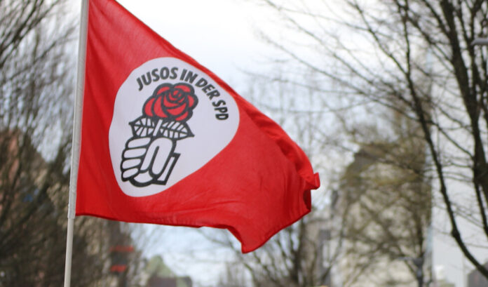 Eine Fahne der Jusos weht im Wind. Foto: Volkmann
