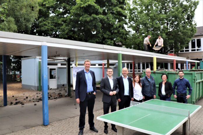 2025-07-16-OGS-Anbau Hösel_Beginn Abrissarbeiten Der Schulhofgang an der Wilhelm-Busch-Schule wird abgerissen, um Platz für einen Ergänzungsanbau zu machen. Den Startschuss für diese Baumaßnahme verfolgten (von links nach rechts) Hochbaudezernent Martin Gentzsch, Erster Beigeordneter Patrick Anders, Geschäftsführer Stefan Zimmermann, Adreola Jaupi und Stefan Welling (beide Stabsstelle Hochbau), Sandra Hölzer-Schramm (Leiterin Schulverwaltungsamt) und Planer Gerrit Gramsch. Foto: Stadt Ratingen