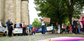 Mit Fahnen und Plakaten haben sich die Demonstranten postiert.
