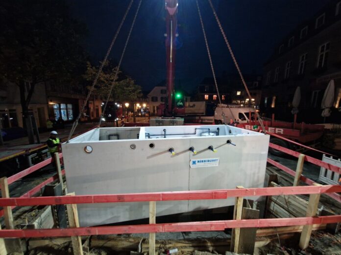 Bereits im Morgengrauen begannen die Arbeiten auf dem Marktplatz, ein großer Mobilkran hievte die Brunnenkammer in die Höhe. Foto: Stadt Ratingen