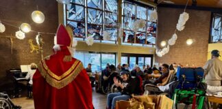 Lebenshilfe feiert stimmungsvoll Der Nikolaus verteilt Geschenktüten an die Gäste der Feier im Pfarrsaal von St. Peter und Paul. Foto: Lebenshilfe Kreis Mettmann