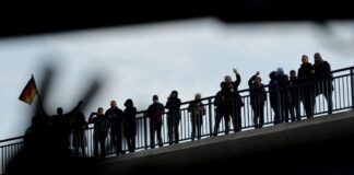 Rahmedetalbrücke wieder frei – Verkehr rollt mit Tempo 80 Schaulustige, die auf einer Brücke in der Nähe der Rahmedetalbrücke stehen, winken nach der Eröffnung einem Bus, der über die Brücke gefahren ist.