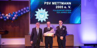 Innenminister Herbert Reul und Polizeidirektor Markus Henkel vom LAFP überreichten Polizeihauptkommissar Peter Creutz die Auszeichnung für den PSV Mettmann als Polizeisportverein des Jahres. Foto: Polizei
