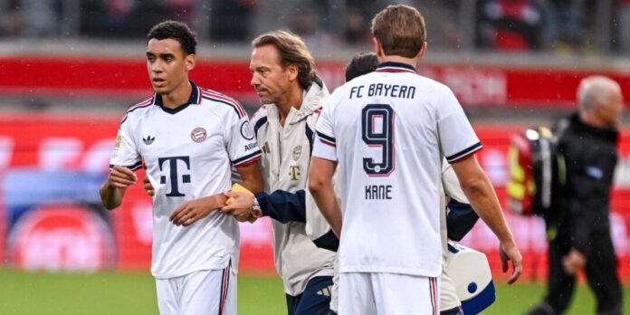 Fußball, Testspiele: 1. FC Heidenheim - FC Bayern München «Mental stark bleiben»: Jamal Musiala verlässt nach seinem Zusammenbruch in Heidenheim den Platz in Begleitung eines Teamarztes.